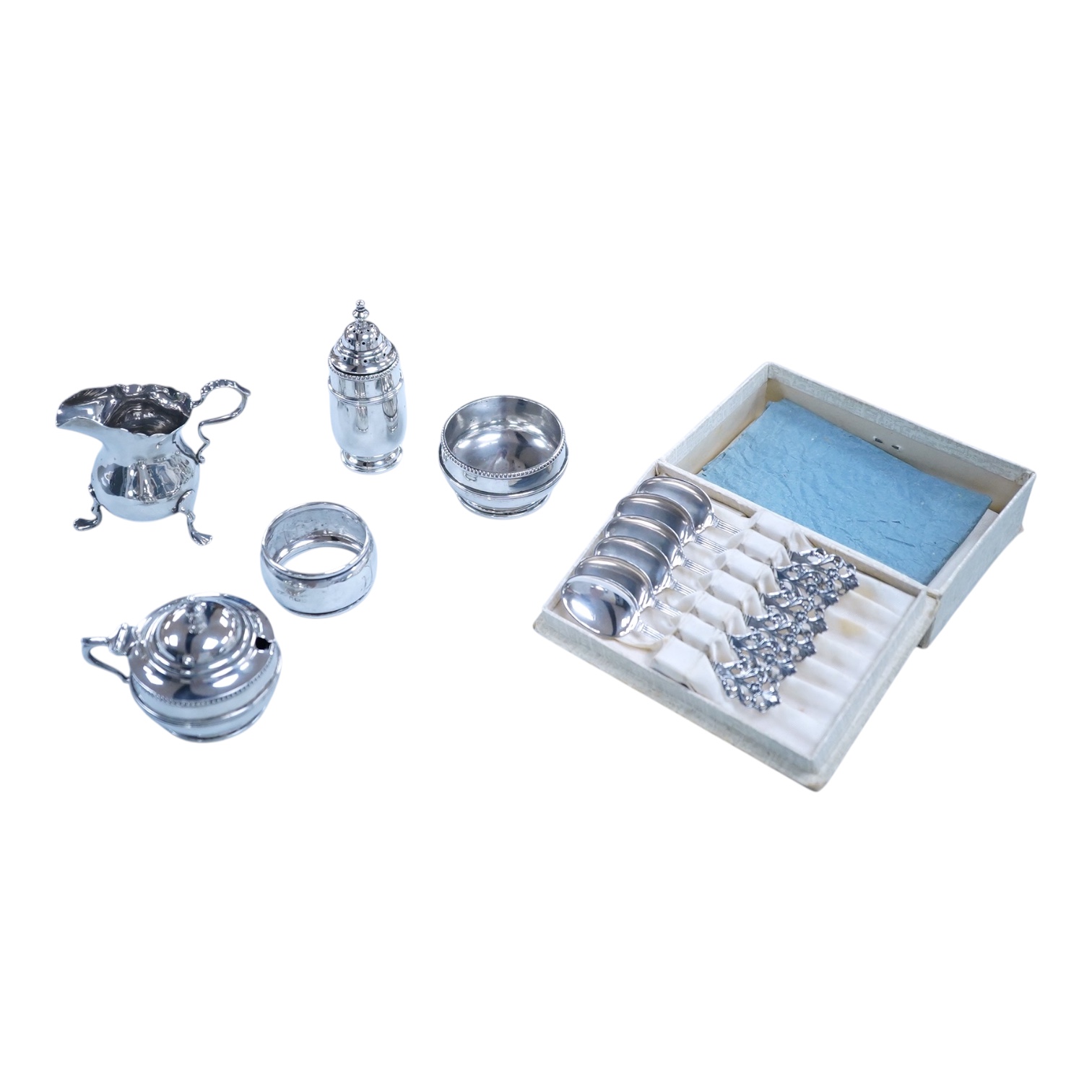 Small silver including a three piece cruet set, by George Howson, Sheffield, 1924/5/6, a napkin ring, a cream jug and a set of six 830s coffee spoons.